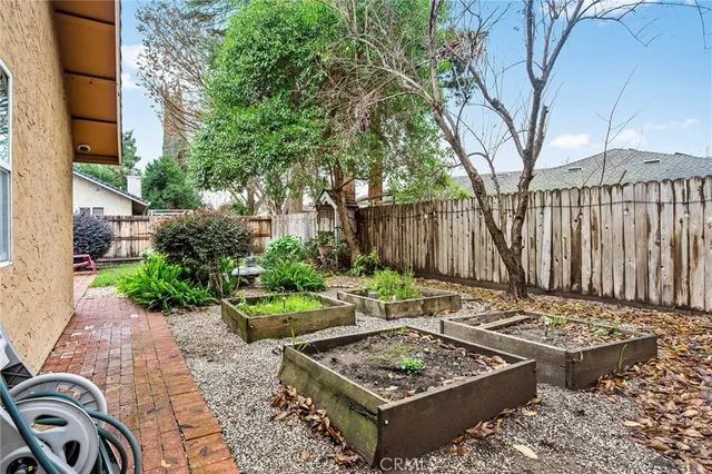 a view of a house with a yard and potted plants
