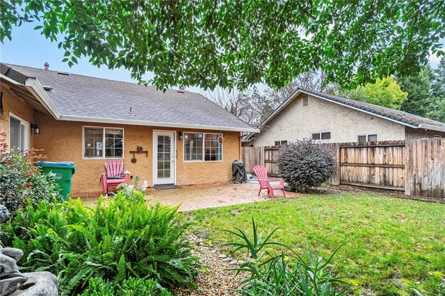 a view of a house with backyard and sitting area