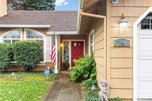 a view of a house with potted plants