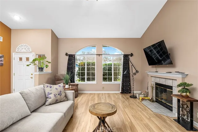 a living room with furniture a fireplace and a flat screen tv
