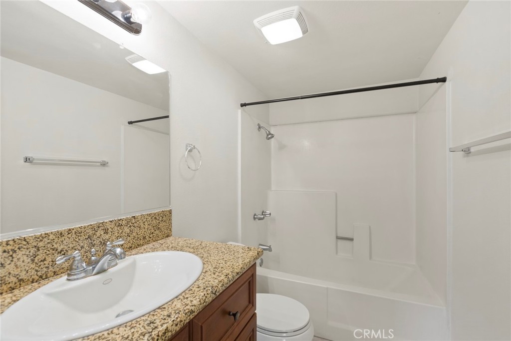 86 Clearbrook, Unit 33 Irvine, CA 92614 - Photo 14 of 20 a bathroom with a granite countertop sink toilet and shower