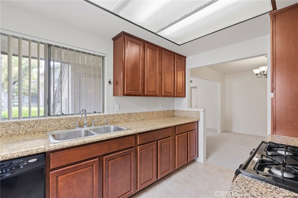 86 Clearbrook, Unit 33 Irvine, CA 92614 - Photo 9 of 20 a kitchen with a sink stove and cabinets