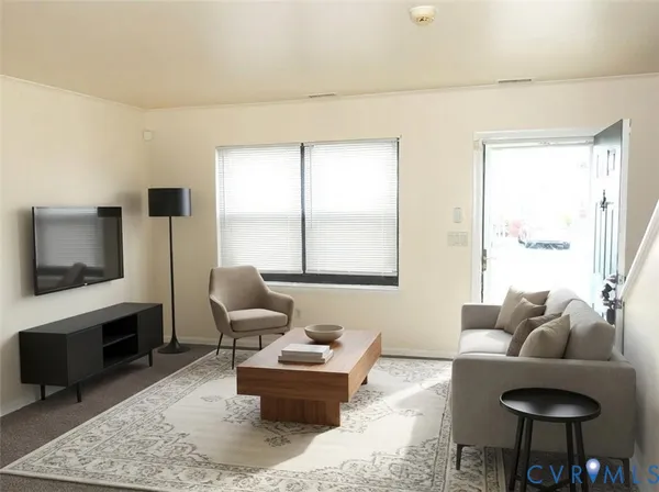 a living room with furniture rug and window