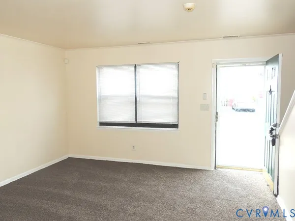 a view of an empty room and a window