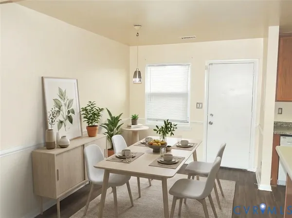 a view of a dining room with furniture and wooden floor