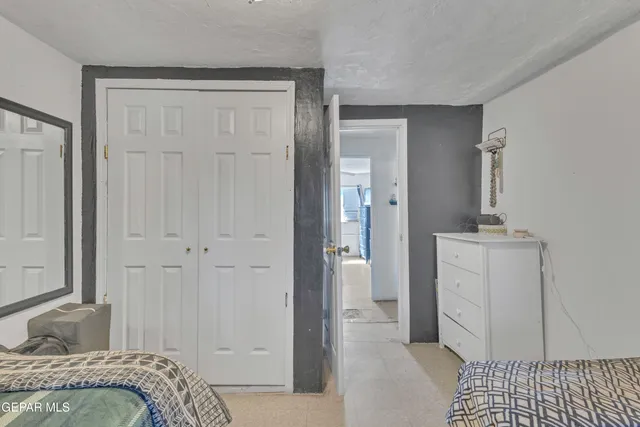 a living room with furniture a chandelier and a large window