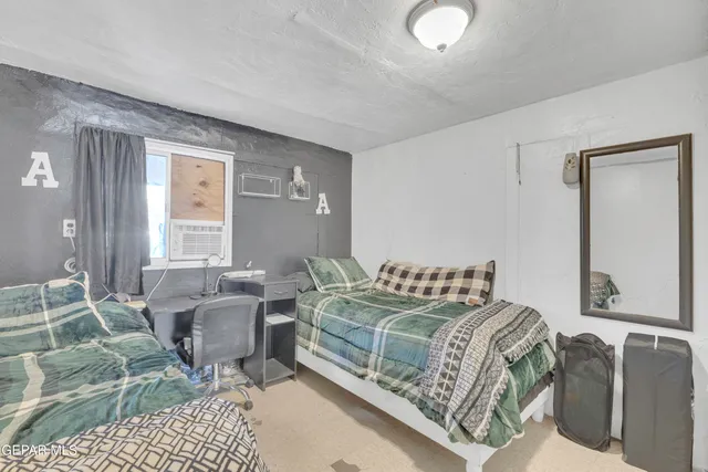 a bedroom with furniture and a window