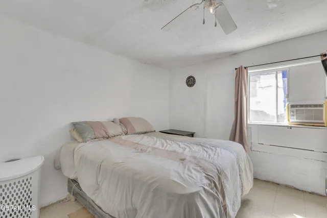 a bedroom with a bed and a window