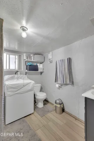 a bathroom with a sink a toilet and a mirror