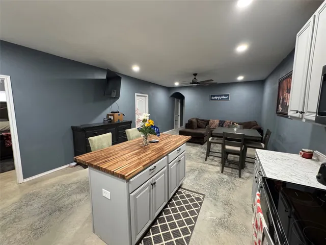 a kitchen with stainless steel appliances kitchen island granite countertop a sink and cabinets