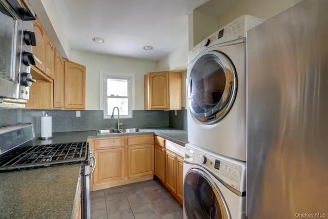 a utility room with sink dryer and washer