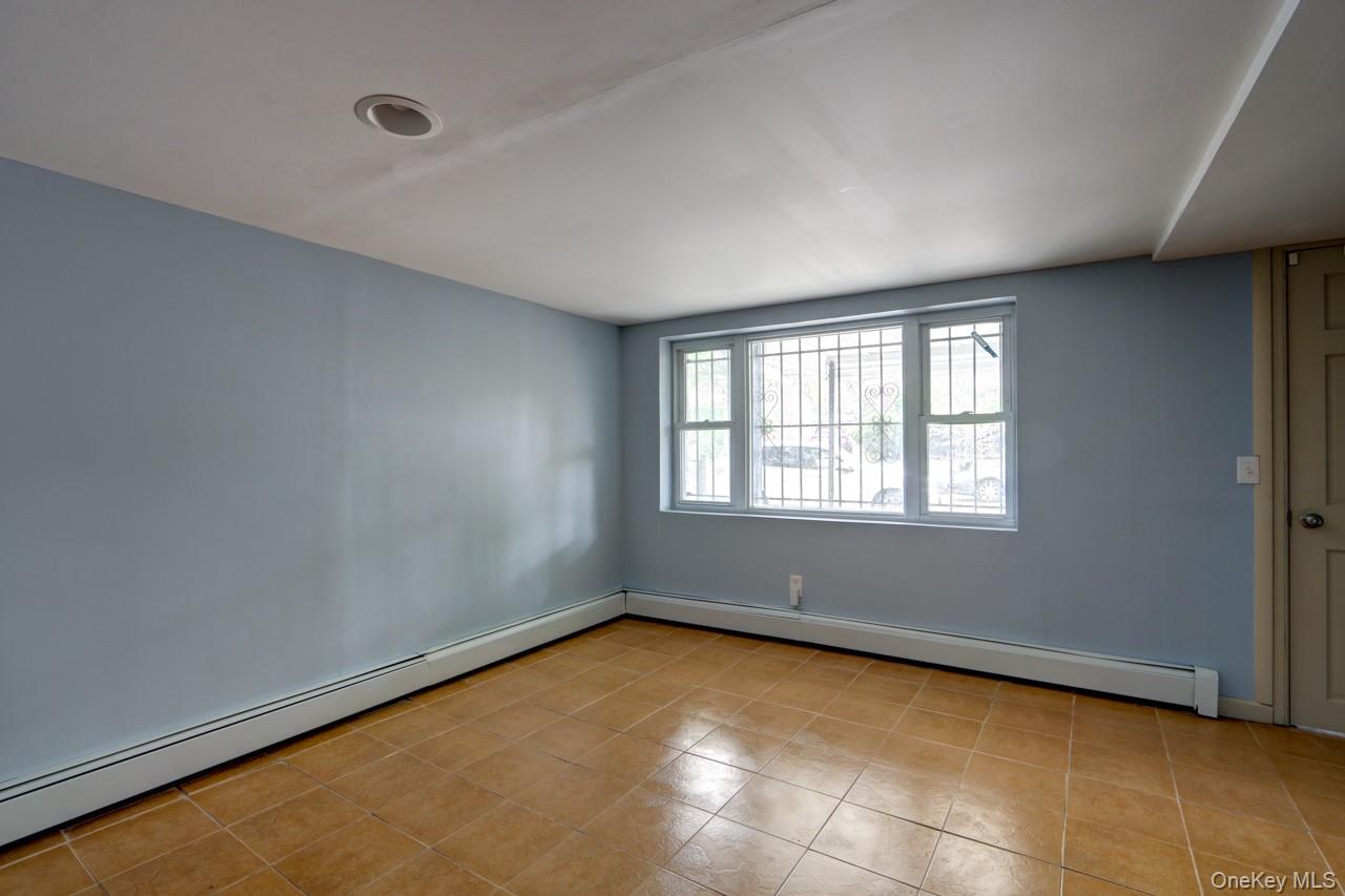 12-67 Waterview Street Queens, NY 11691 - Photo 11 of 14 a view of an empty room with a window