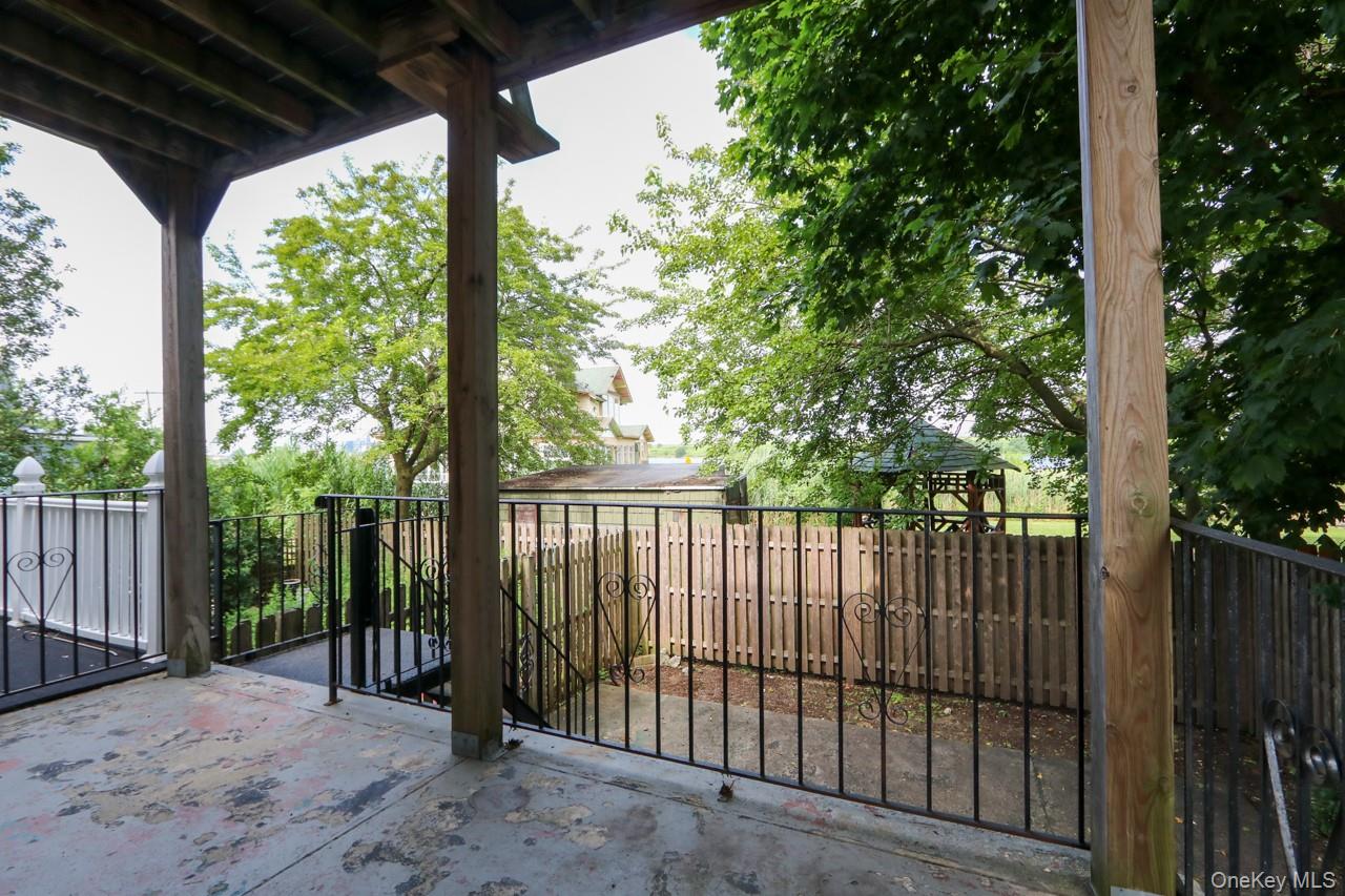 12-67 Waterview Street Queens, NY 11691 - Photo 13 of 14 a view of porch with trees