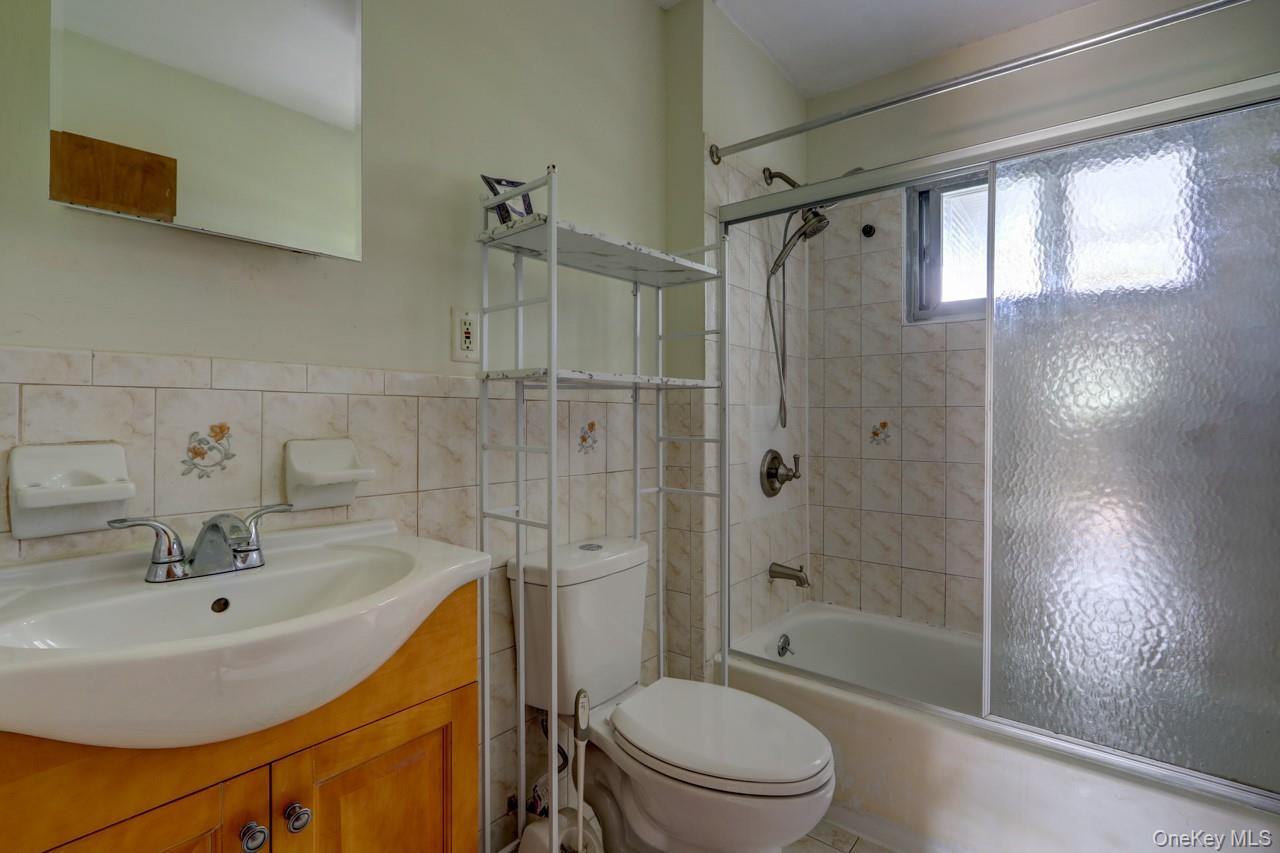 12-67 Waterview Street Queens, NY 11691 - Photo 6 of 14 a bathroom with a sink toilet and shower