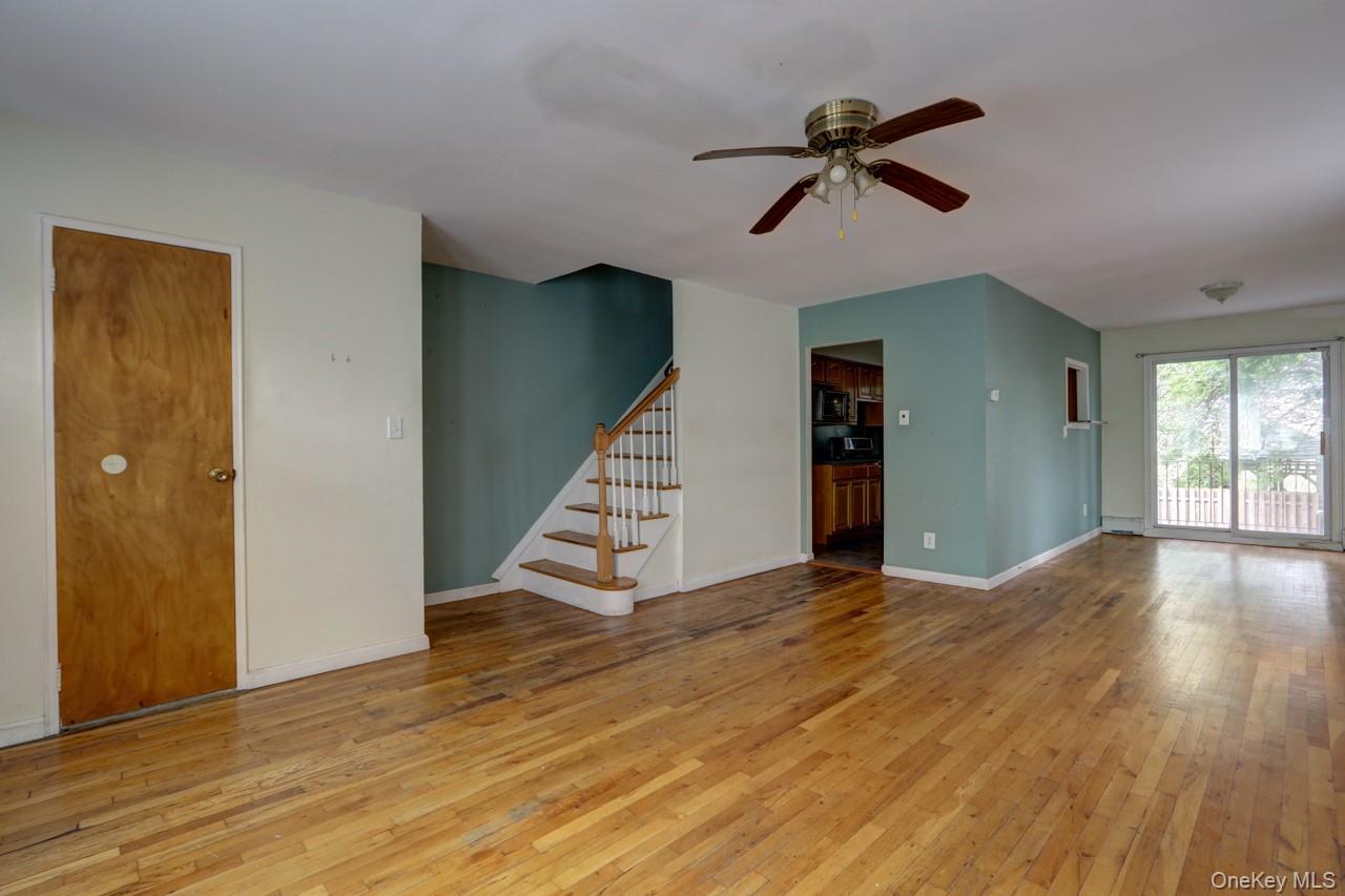 12-67 Waterview Street Queens, NY 11691 - Photo 10 of 14 a view of empty room with wooden floor and ceiling fan
