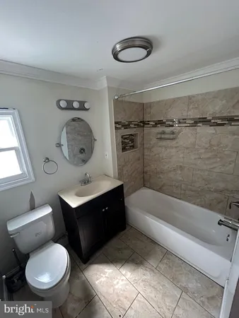 a bathroom with a toilet a sink and bathtub