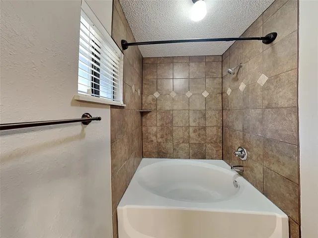 a bathroom with a bathtub and shower