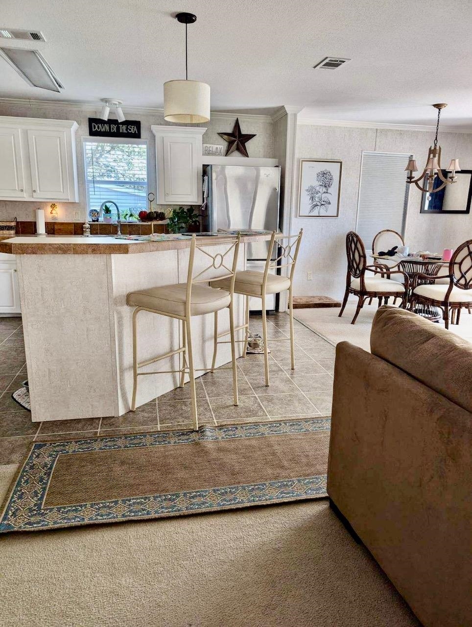 292 Majorca Road Butler Beach, FL 32080 - Photo 12 of 27 a view of a kitchen with kitchen island stainless steel appliances granite countertop a stove a sink a dining table and chairs