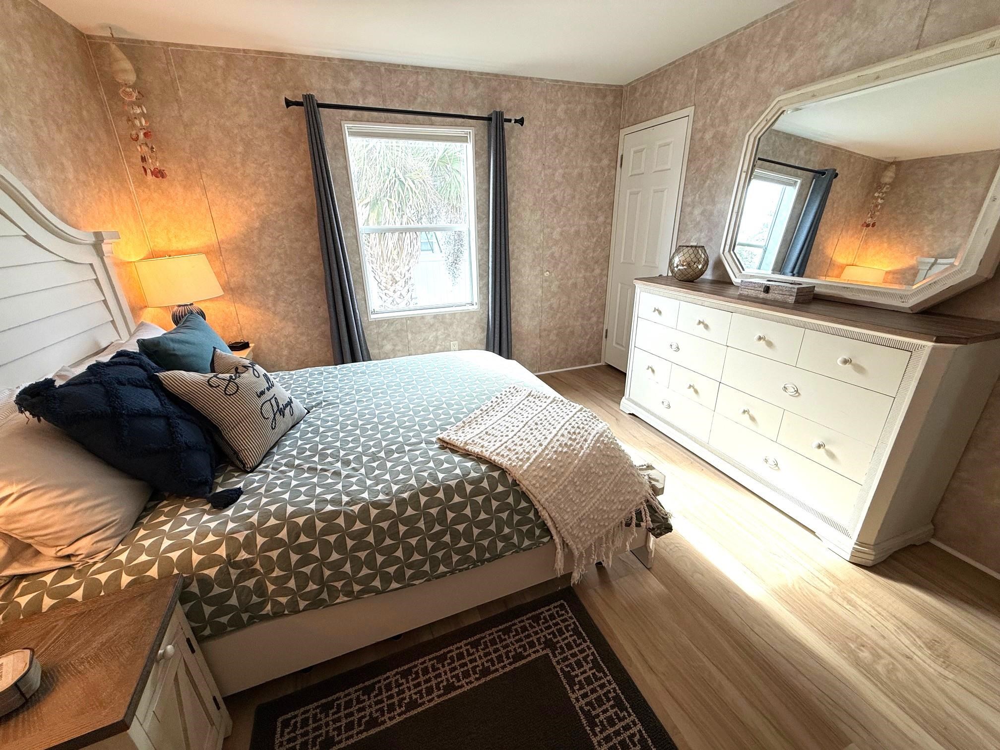 292 Majorca Road St. Augustine, FL 32080 - Photo 14 of 32 a bedroom with a bed a mirror on dresser and a window