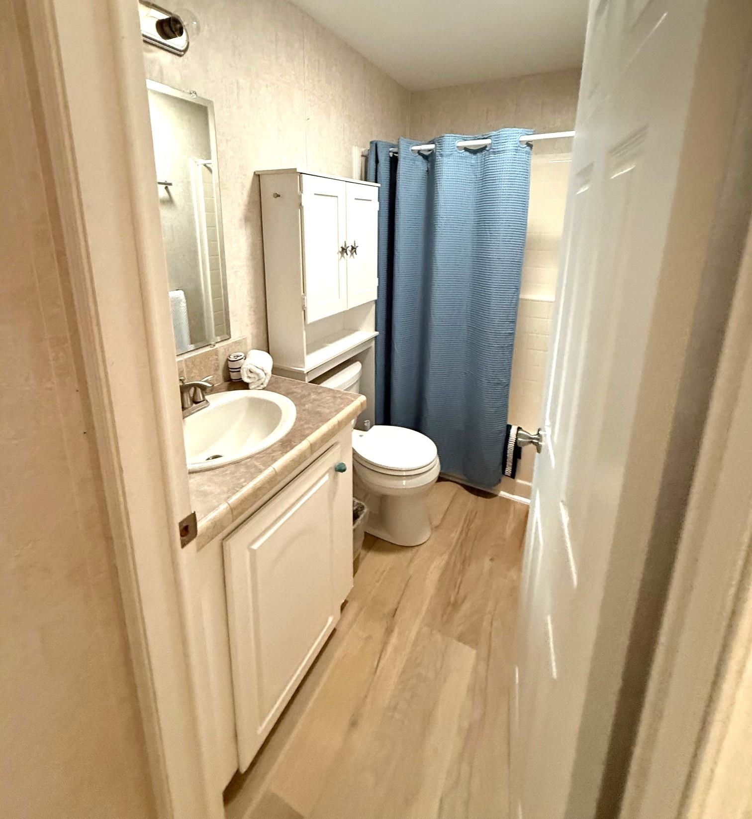 292 Majorca Road St. Augustine, FL 32080 - Photo 16 of 32 Full bathroom featuring vanity, a shower with shower curtain, and light wood-type flooring