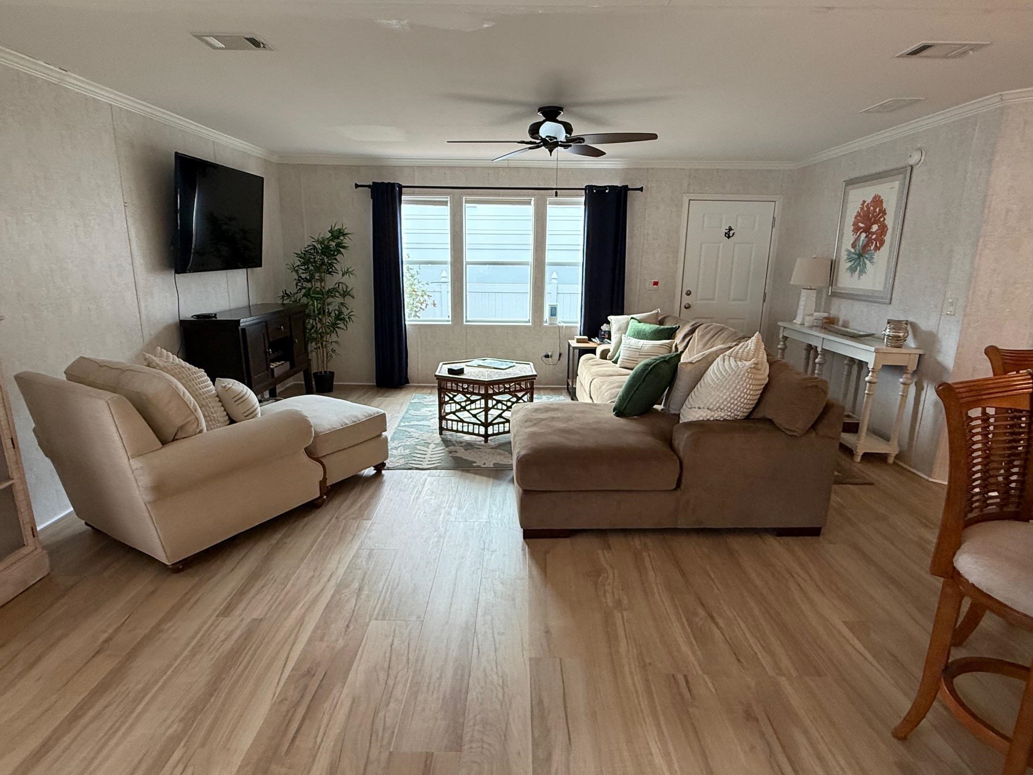292 Majorca Road St. Augustine, FL 32080 - Photo 8 of 32 Living area with light wood finished floors, a ceiling fan, and ornamental molding