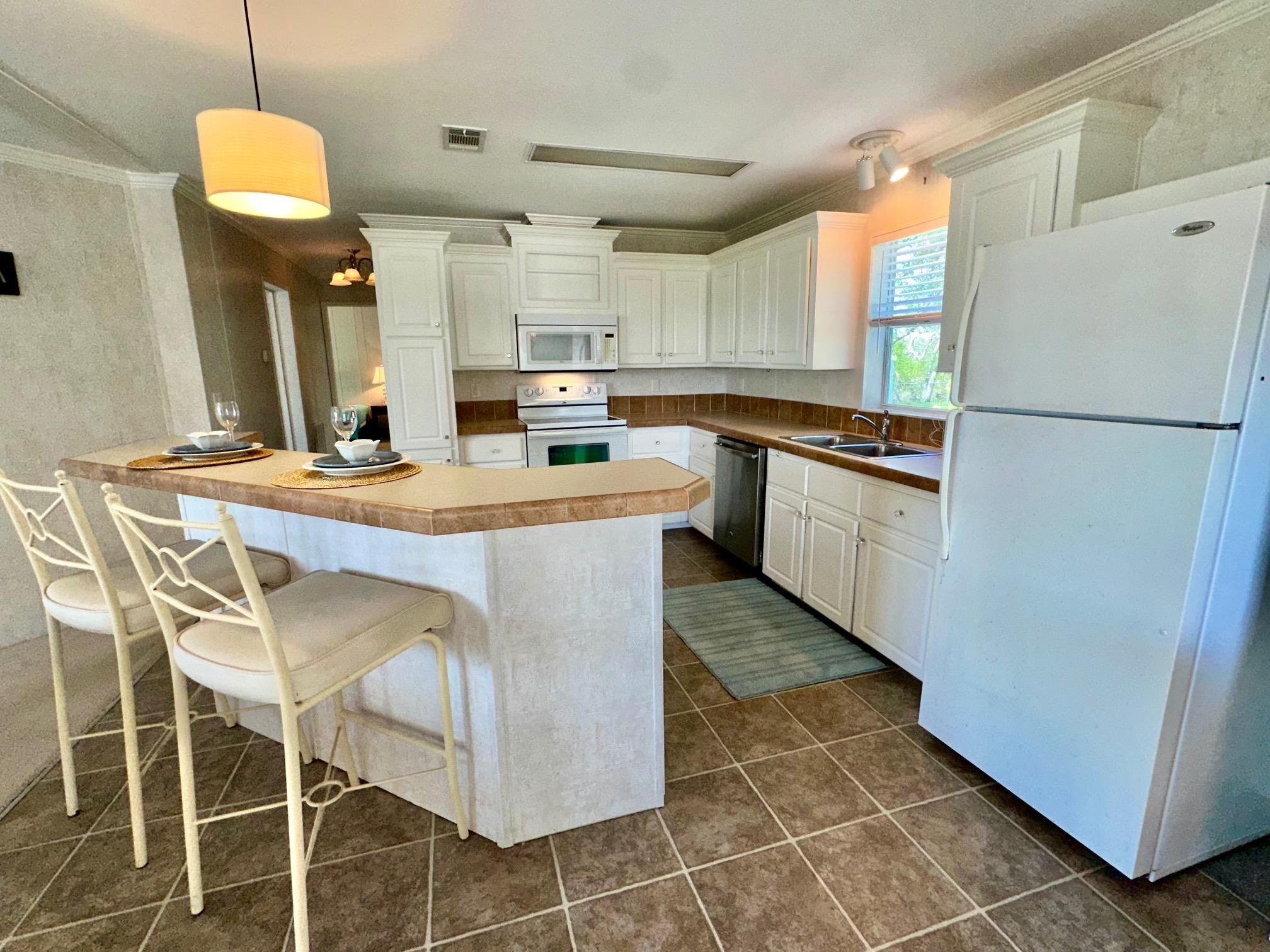 292 Majorca Road Butler Beach, FL 32080 - Photo 8 of 27 a kitchen with kitchen island a counter top space appliances and cabinets