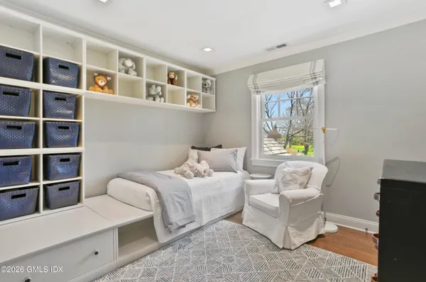a bedroom with a bed furniture and a window