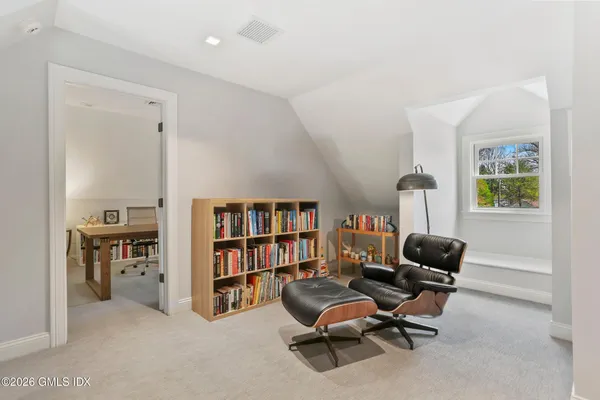 a view of a workspace with furniture and a bookshelf
