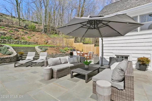 a view of a patio with couches under an umbrella