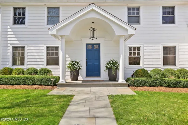 a front view of a house with garden