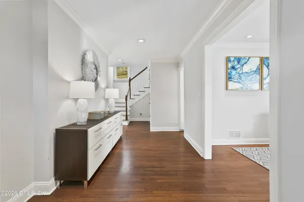 a large kitchen with a stove and a wooden floor