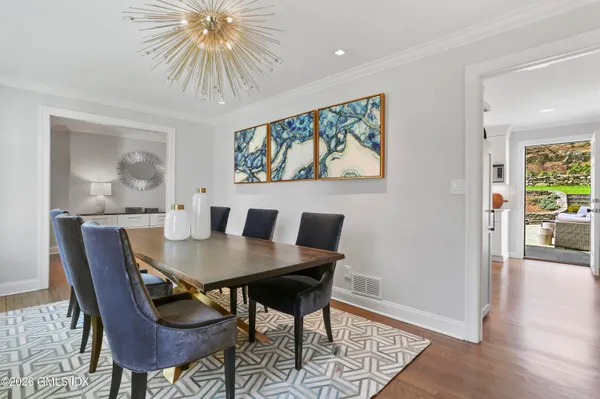 a view of a dining room with furniture and wooden floor