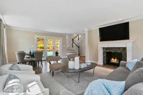 a living room with furniture a flat screen tv and a fireplace
