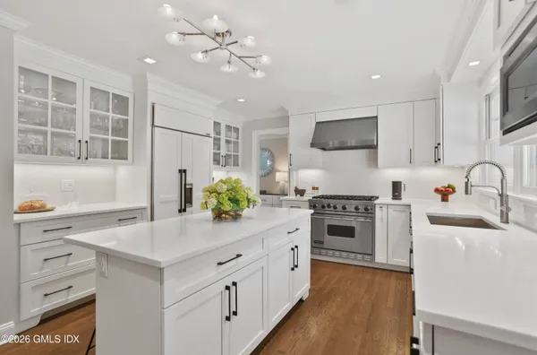 a kitchen with a sink stove and refrigerator