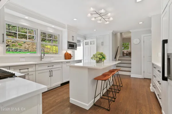 a kitchen with stainless steel appliances granite countertop a stove and a sink
