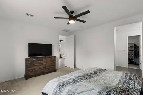 a bedroom with a bed and a flat screen tv