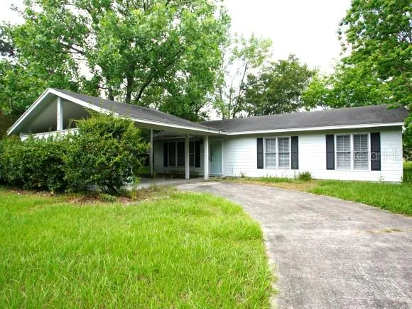 a front view of house with yard and green space