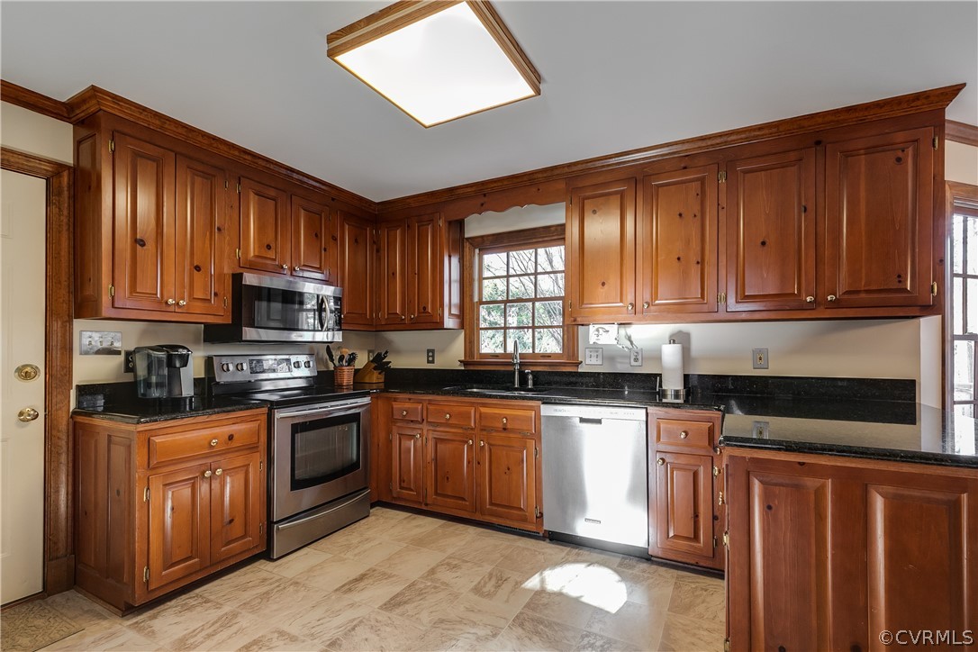 538 Courthouse Road Richmond, VA 23236 - Photo 11 of 24 a kitchen with stainless steel appliances granite countertop wooden cabinets a sink and dishwasher a stove top oven with wooden floor