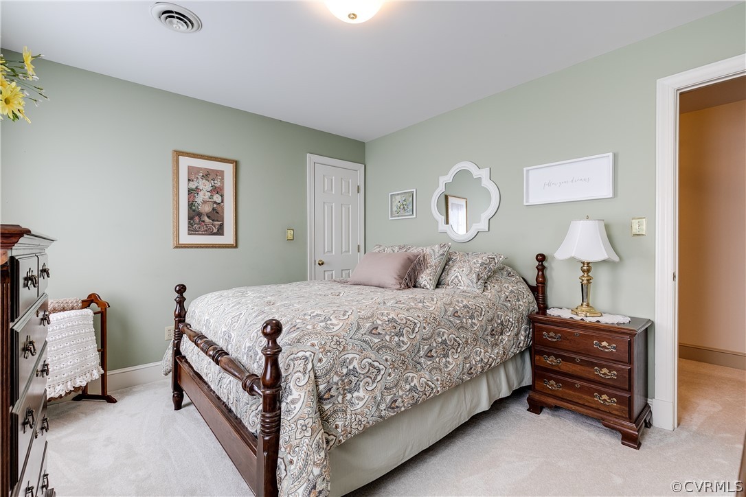 538 Courthouse Road Richmond, VA 23236 - Photo 16 of 24 a bedroom with a bed and a chandelier