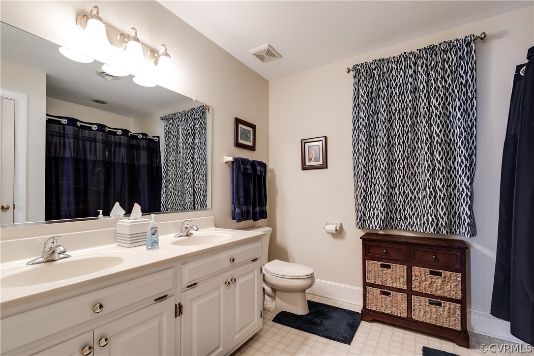 538 Courthouse Road Richmond, VA 23236 - Photo 19 of 24 a bathroom with a sink a toilet and a large mirror