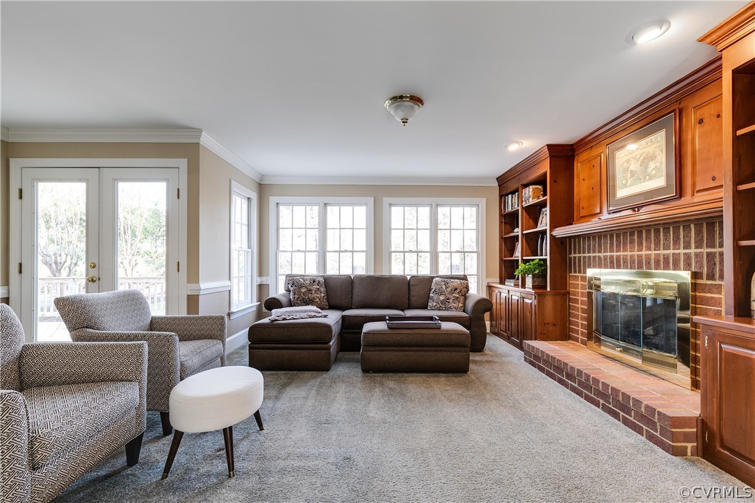 538 Courthouse Road Richmond, VA 23236 - Photo 7 of 24 a living room with furniture a fireplace and a large window
