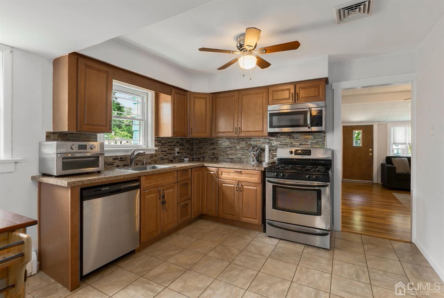 36 Landvale Road Spotswood, NJ 08884 - Photo 6 of 15 a kitchen with stainless steel appliances granite countertop a stove and a sink