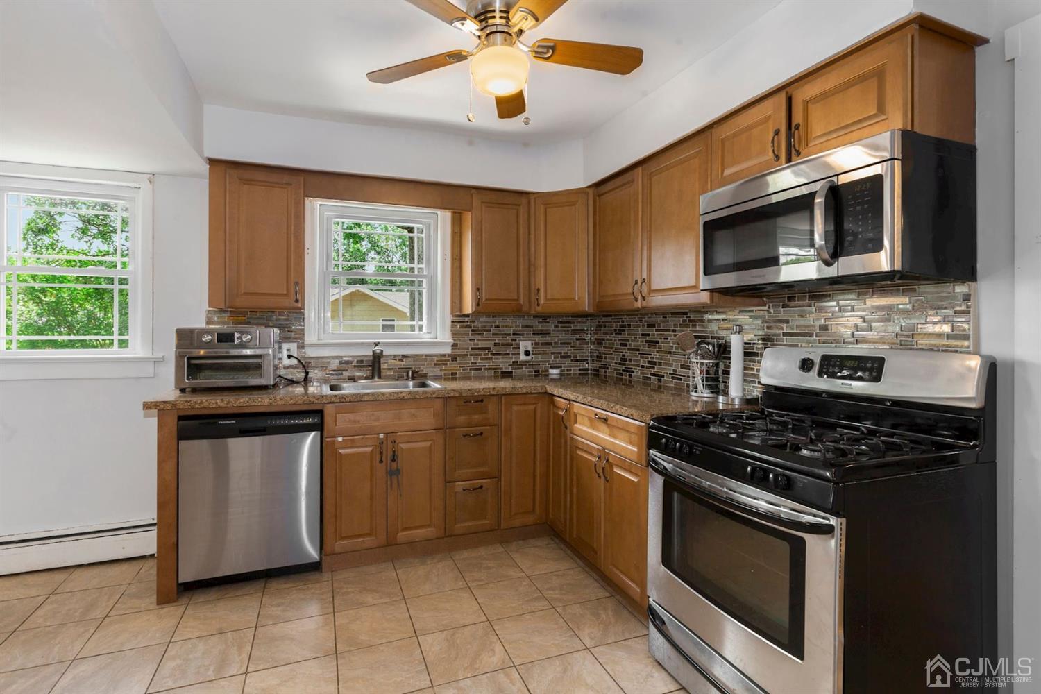 36 Landvale Road Spotswood, NJ 08884 - Photo 7 of 15 a kitchen with stainless steel appliances granite countertop a stove a sink and a microwave