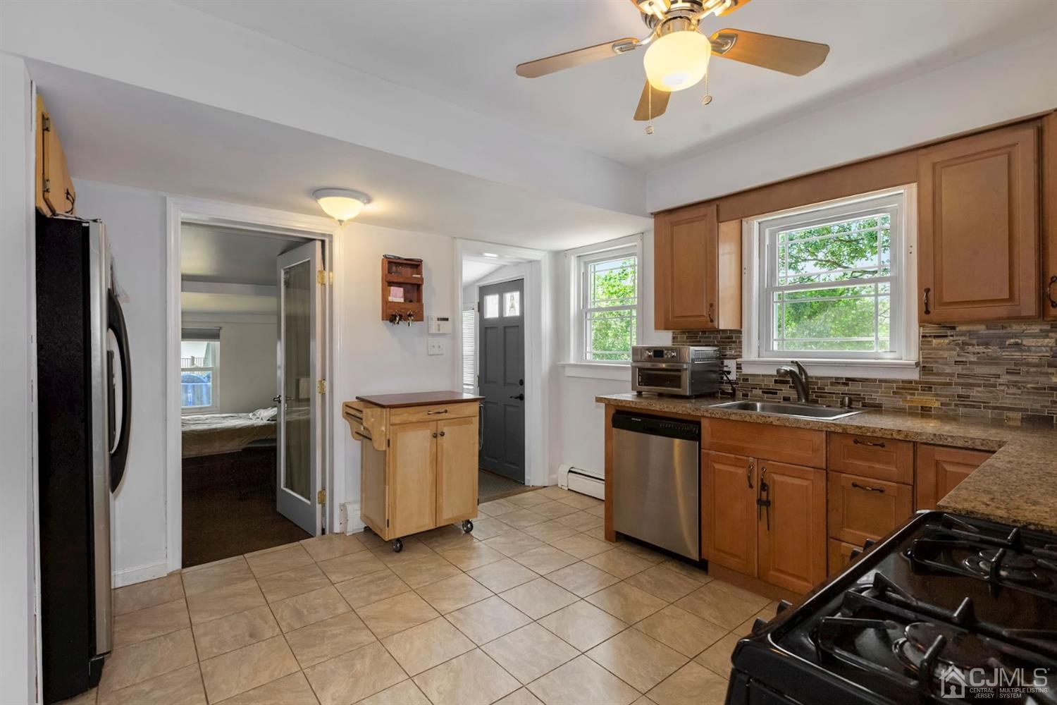 36 Landvale Road Spotswood, NJ 08884 - Photo 8 of 15 a kitchen with a stove a sink and a refrigerator