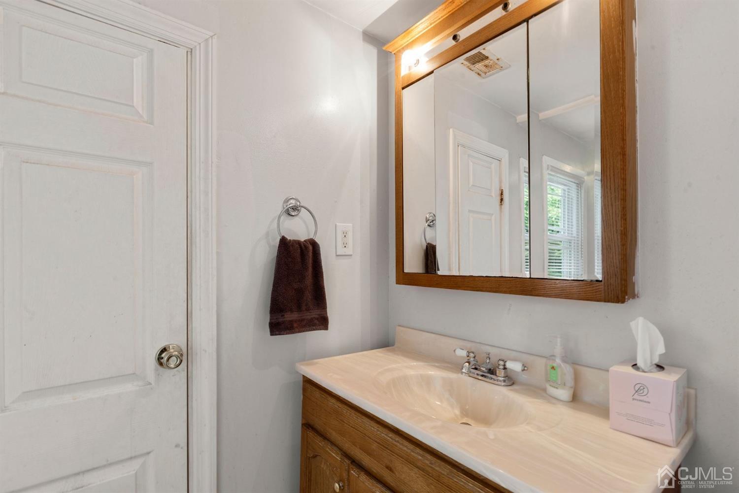 36 Landvale Road Spotswood, NJ 08884 - Photo 9 of 15 a bathroom with a sink and a mirror