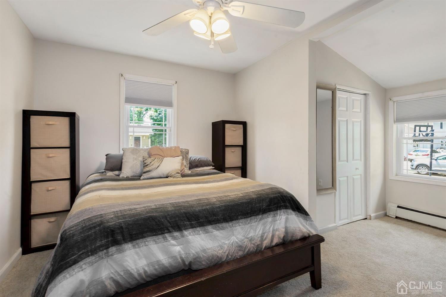 36 Landvale Road Spotswood, NJ 08884 - Photo 10 of 15 a bedroom with a large bed and a chandelier