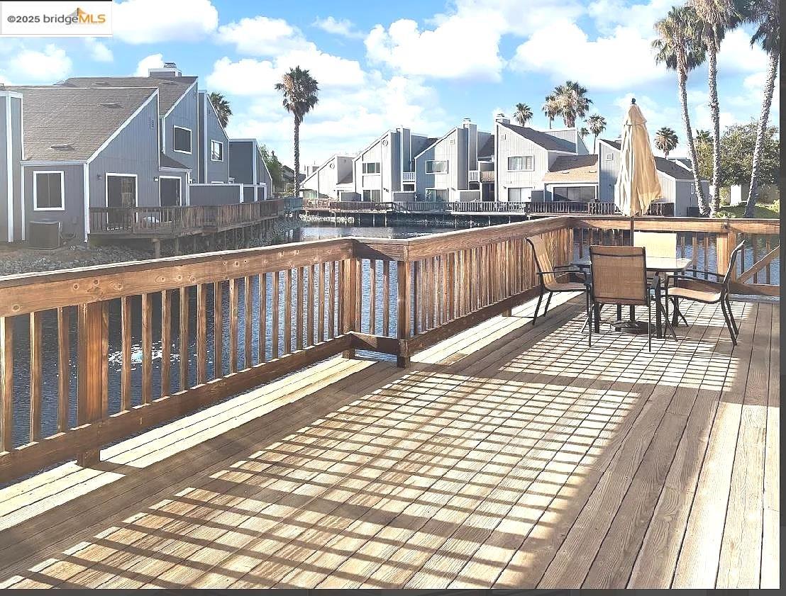 2033 Sand Point Road Discovery Bay, CA 94505 - Photo 12 of 17 Wooden deck featuring a residential view, outdoor dining area, and a water view