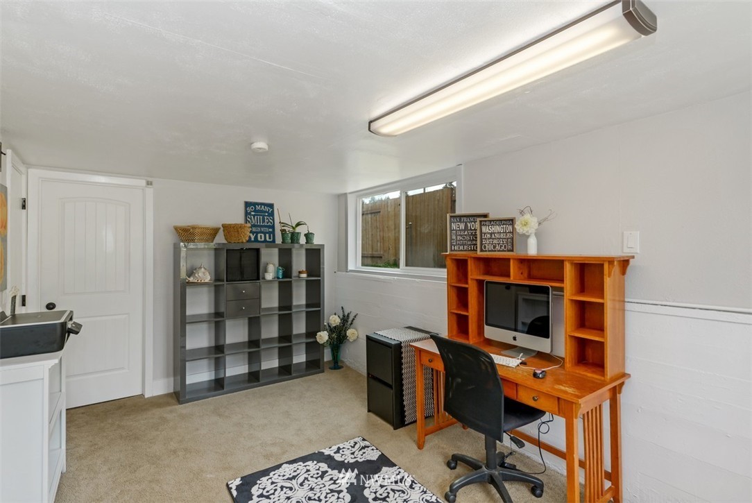808 Electron Way Fircrest, WA 98466 - Photo 13 of 20 a view of a workspace with furniture and wooden floor