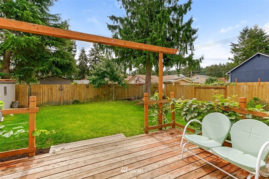 808 Electron Way Fircrest, WA 98466 - Photo 15 of 20 a view of a roof deck with wooden floor and fence
