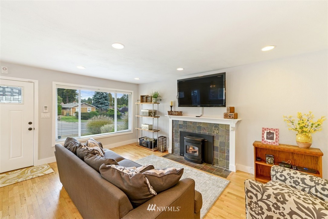 808 Electron Way Fircrest, WA 98466 - Photo 3 of 20 a living room with furniture a fireplace and a flat screen tv